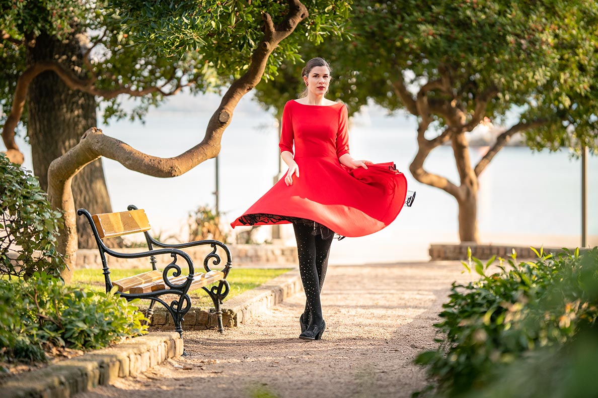 Vintage-Fashion-Bloggerin RetroCat in einem roten Kleid mit schwingendem Tellerrock in Kroatien (Krk)