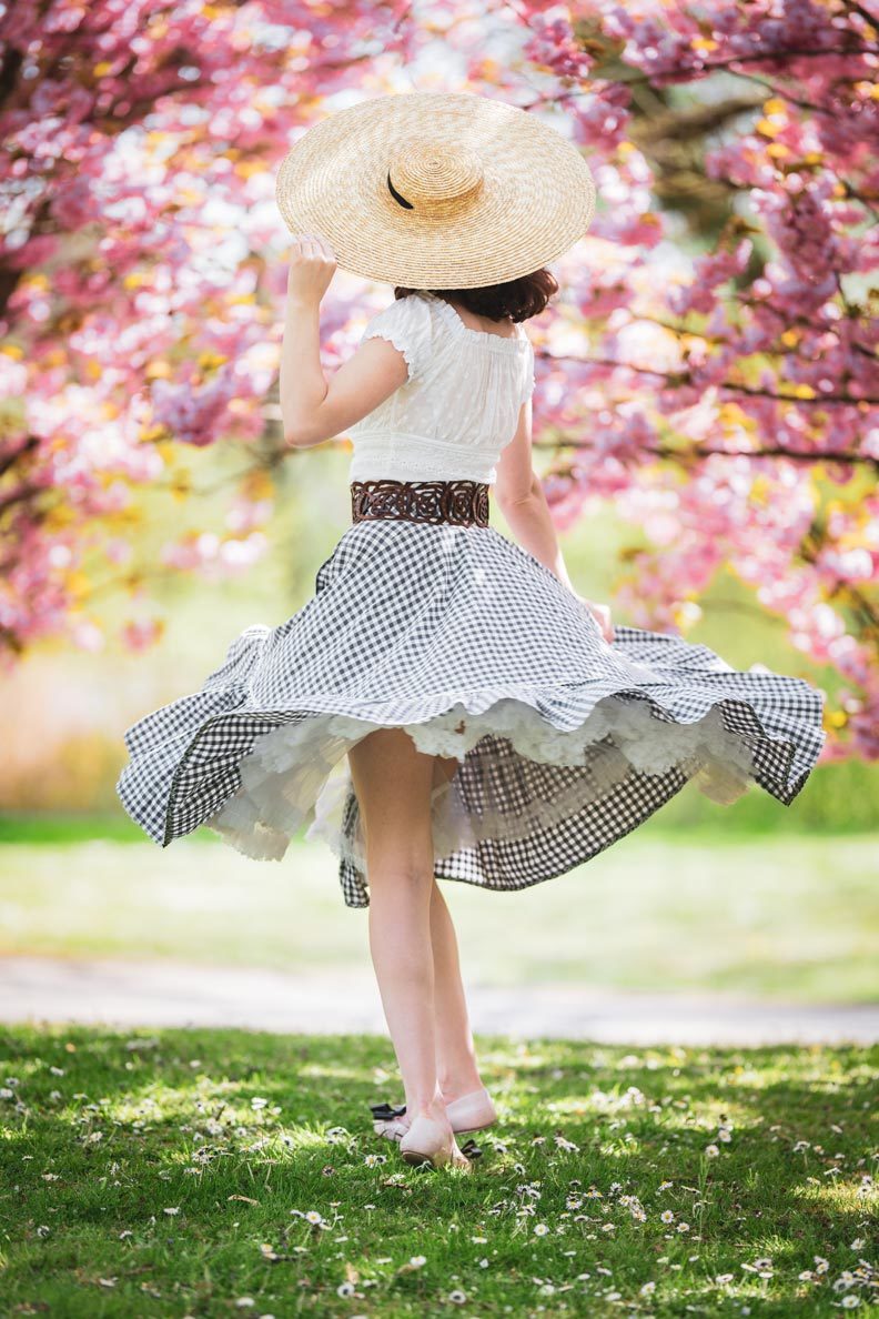 RetroCat with a circle skirt by Lena Hoschek, a romantic top, and big hat