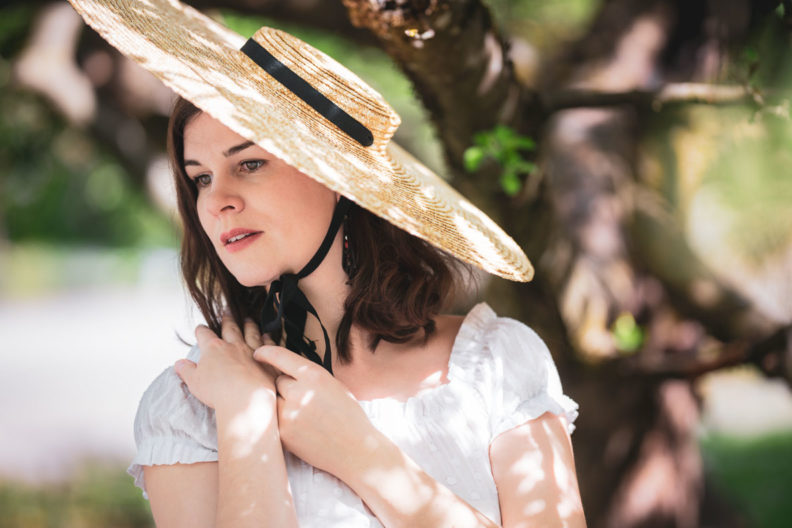 RetroCat wearing a big straw hat in summer