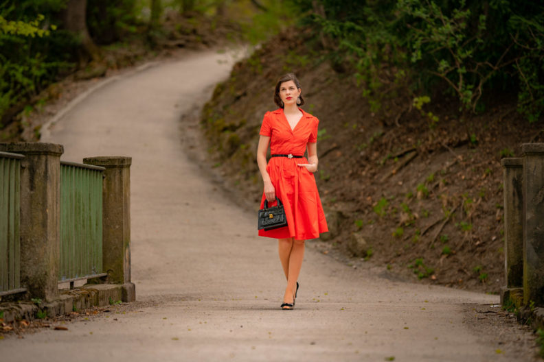 RetroCat wearing a coral-coloured dress and black retro accessories