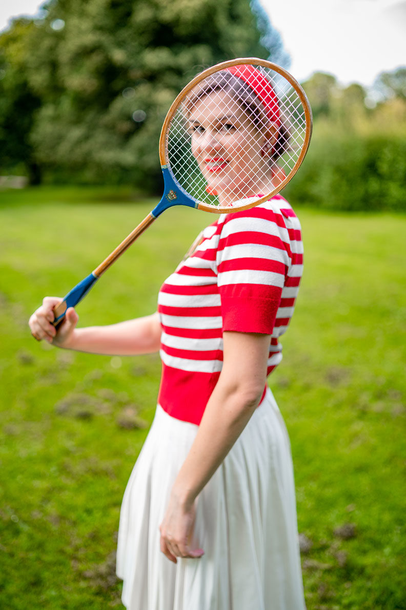 RetroCat during a badminton match wearing a chic vintage outfit