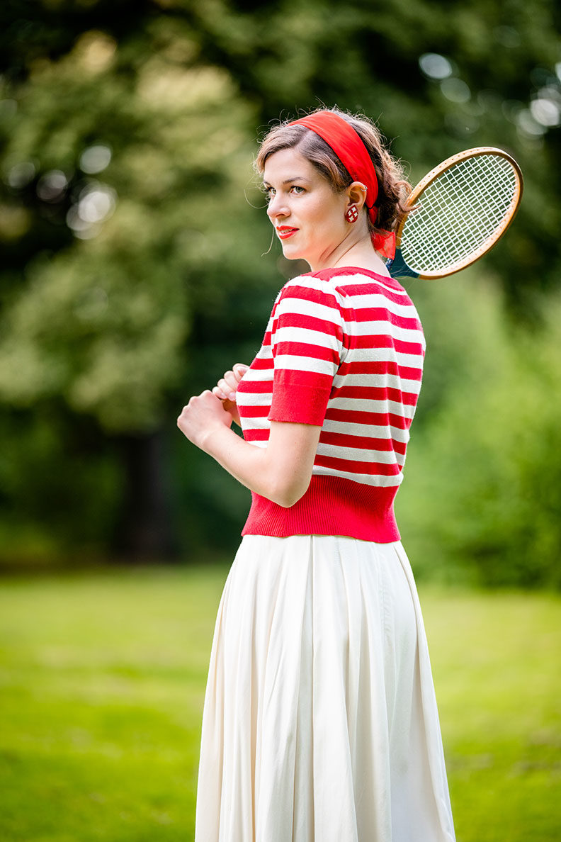 RetroCat with a striped top and white skirt inspired by the 1930s