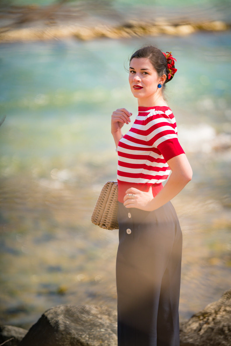 RetroCat with a striped sweater and swing pants in navy at the waterside