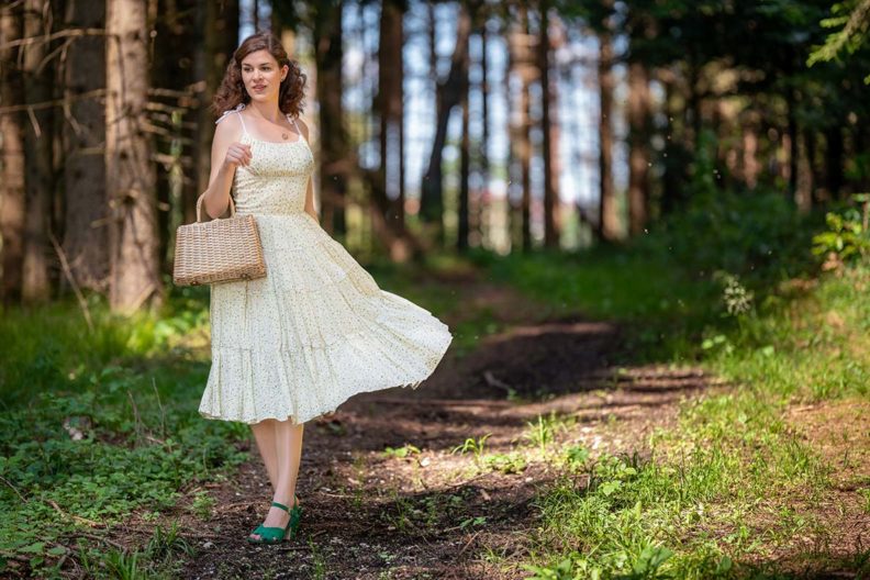 RetroCat mit einem schwingenden Sommerkleid im Vintage-Stil auf dem Land