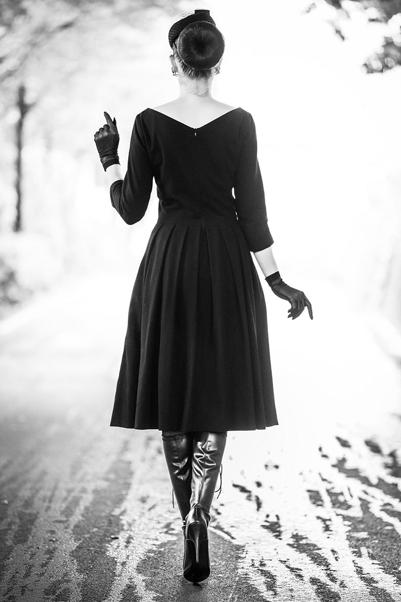 RetroCat wearing a black retro dress in a tunnel