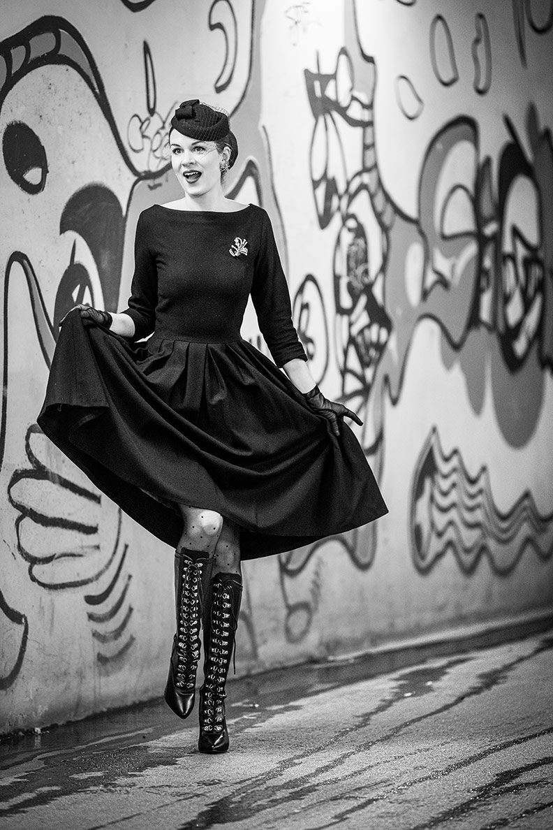 RetroCat wearing a black dress and lace-up boots for autumn
