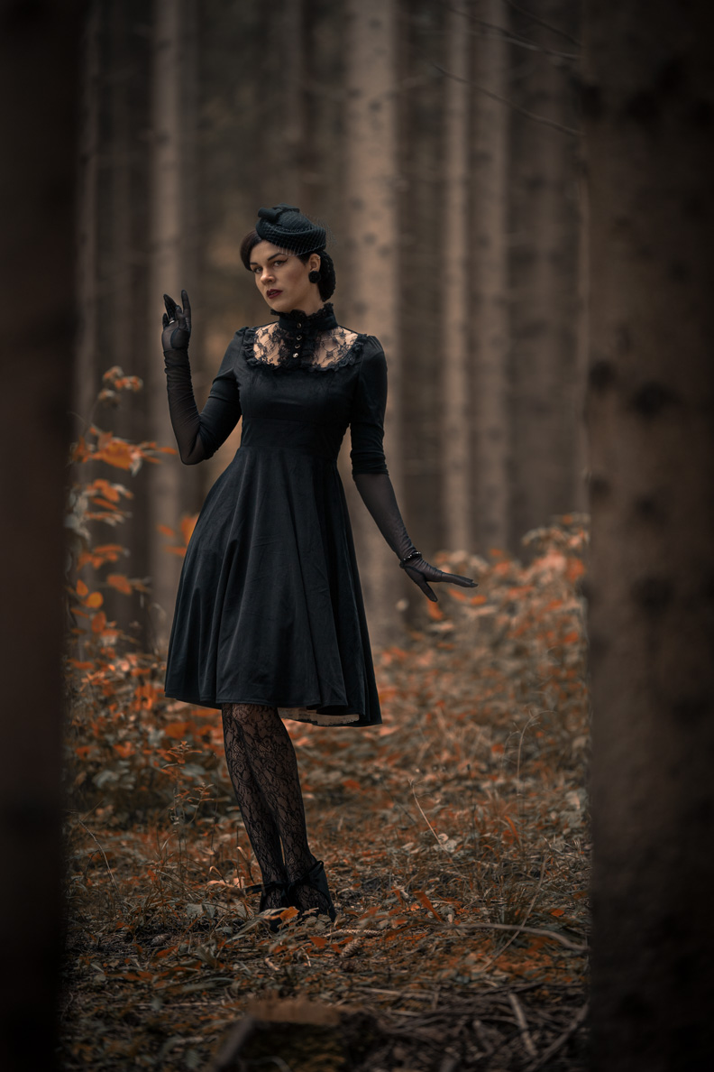 RetroCat wearing lace tights and a gothic dress