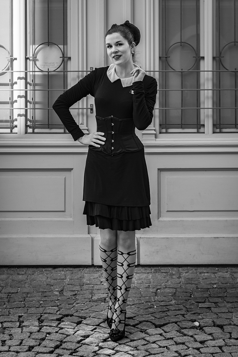 RetroCat wearing a black dress with a white collar and a corset
