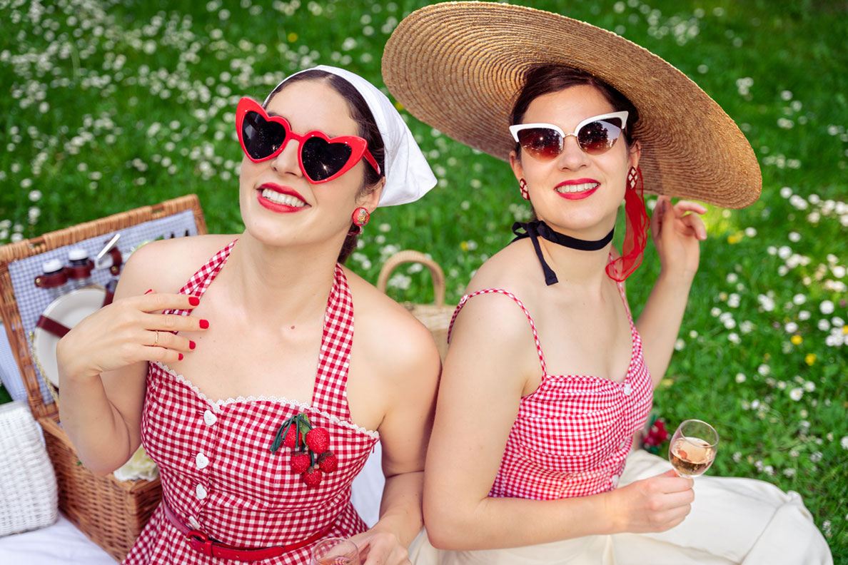 RetroCat and a friend wearing cool retro sunglasses and headdresses in the park