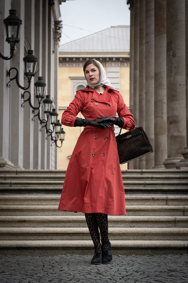 RetroCat wearing a rusty red trench coat by Ginger Jackie and vintage accessories