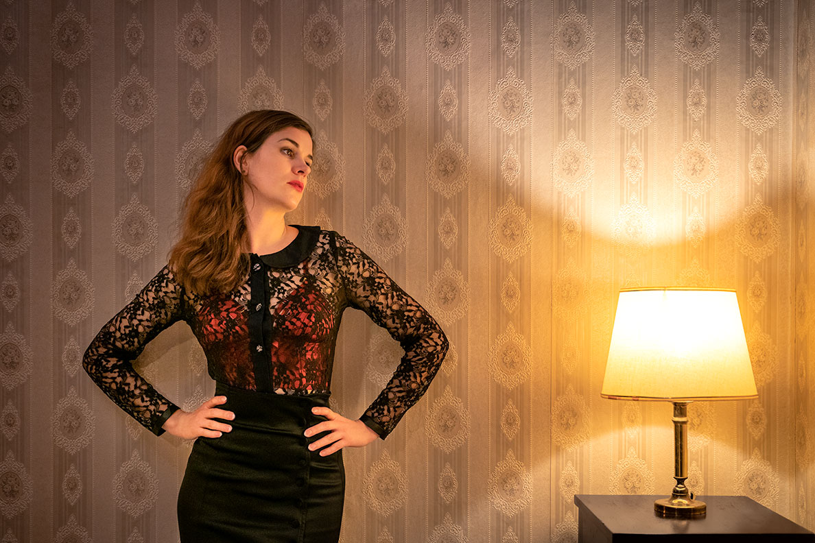 RetroCat wearing a sheer lace blouse over her red bra by Atelier Bordelle