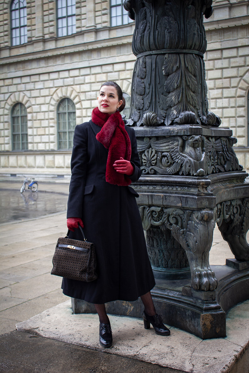 RetroCat wearing a glamorous fake-fur scarf and an elegant coat