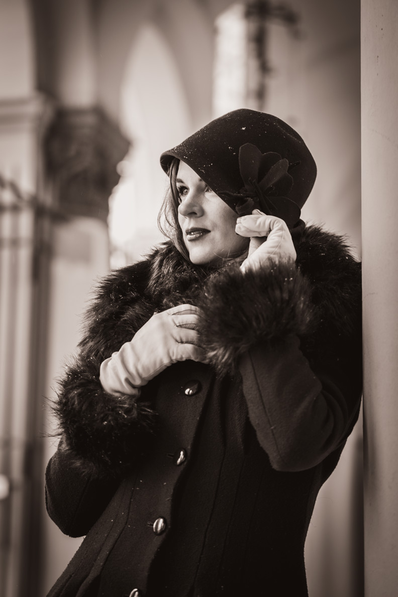 RetroCat wearing an elegant cloche hat with her winter coat