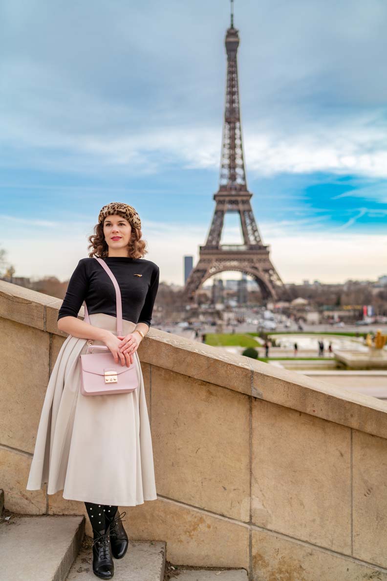RetroCat wearing a circle skirt and a pink handbag in Paris