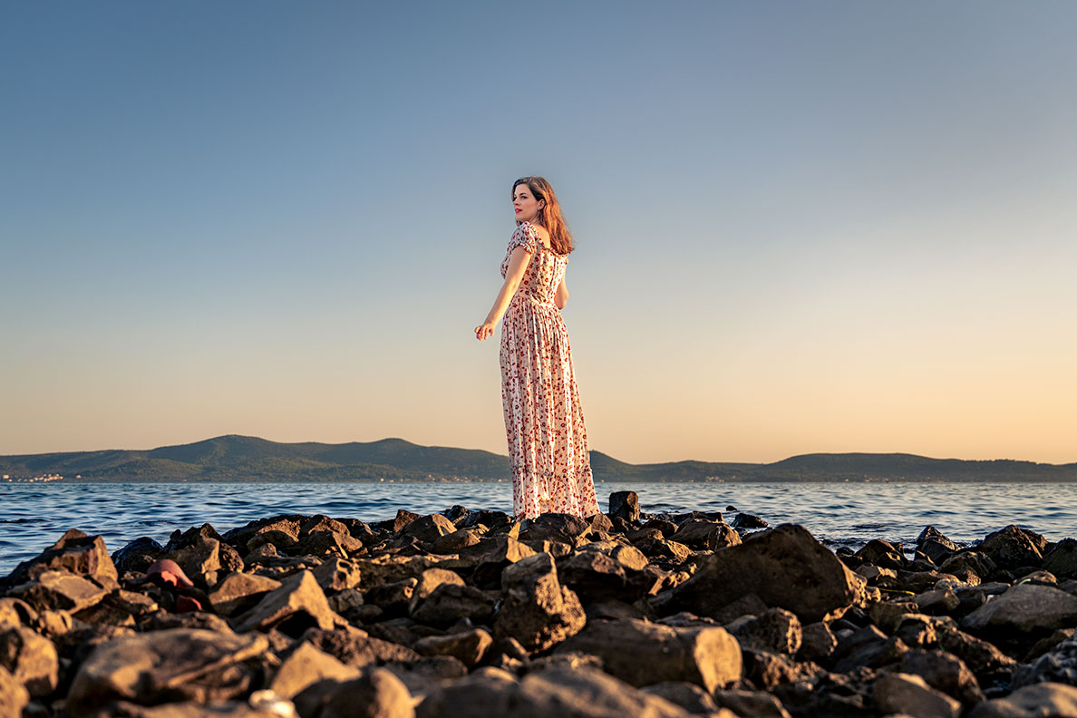 RetroCat wearing a long summer dress at the beach in Croatia