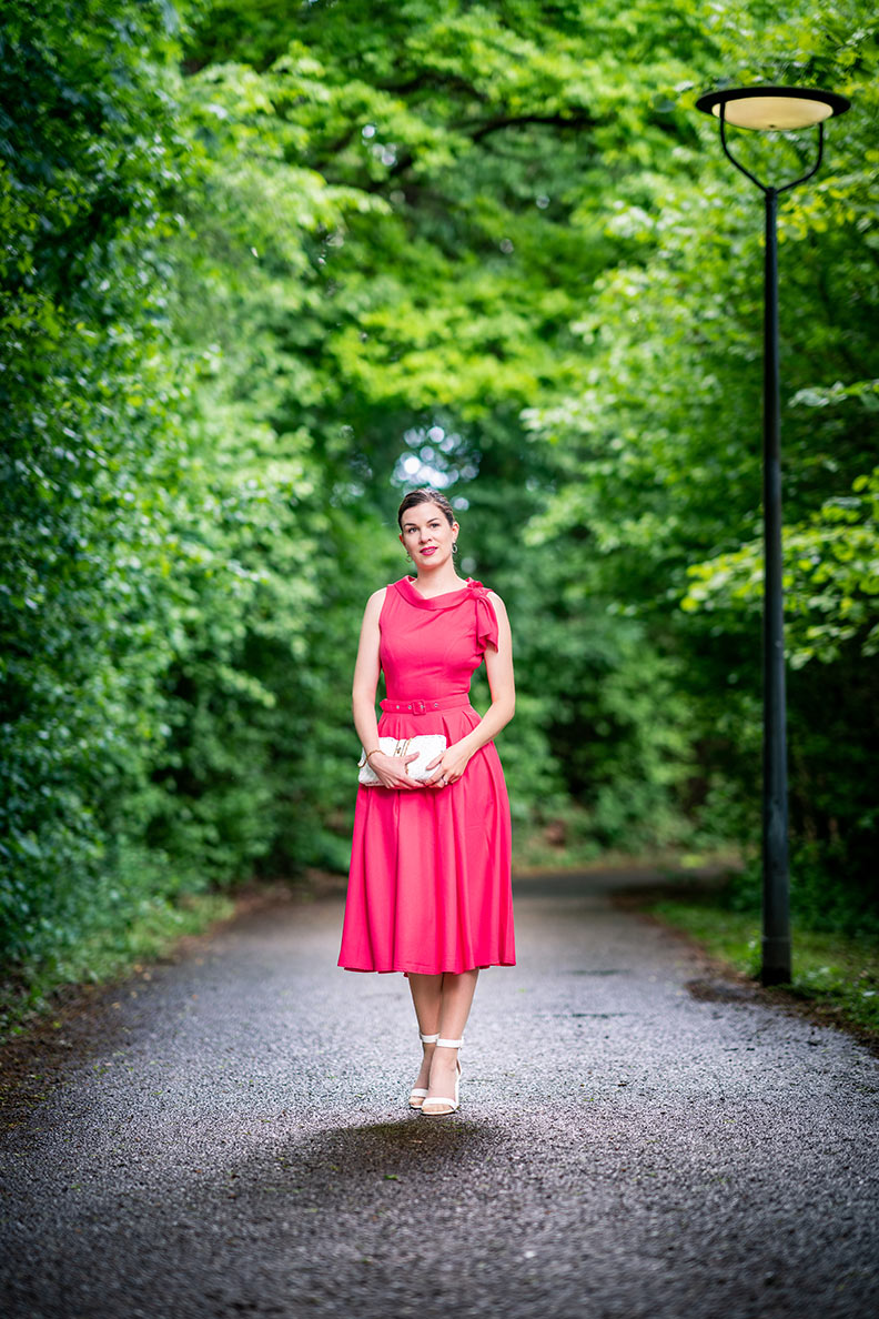 Wedding guest outfit: RetroCat wearing a coral-coloured dress