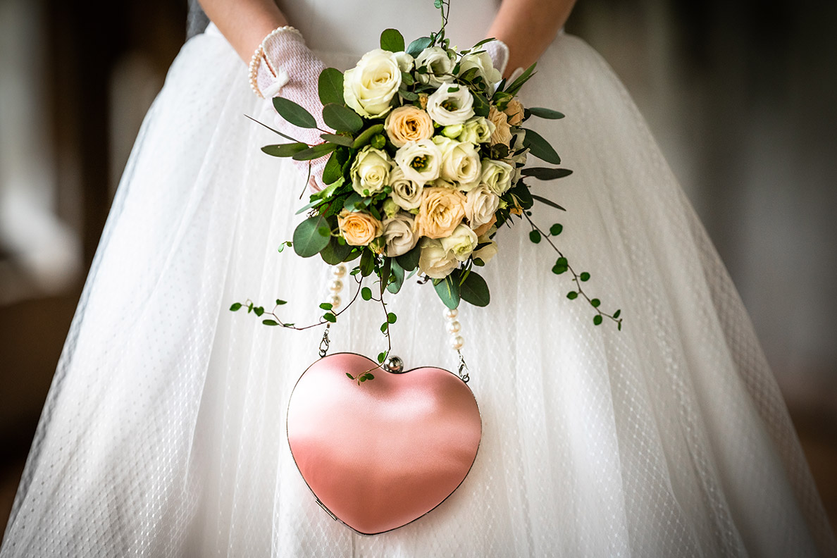 RetroCat with her heart-shaped bridal handbag in a light pink