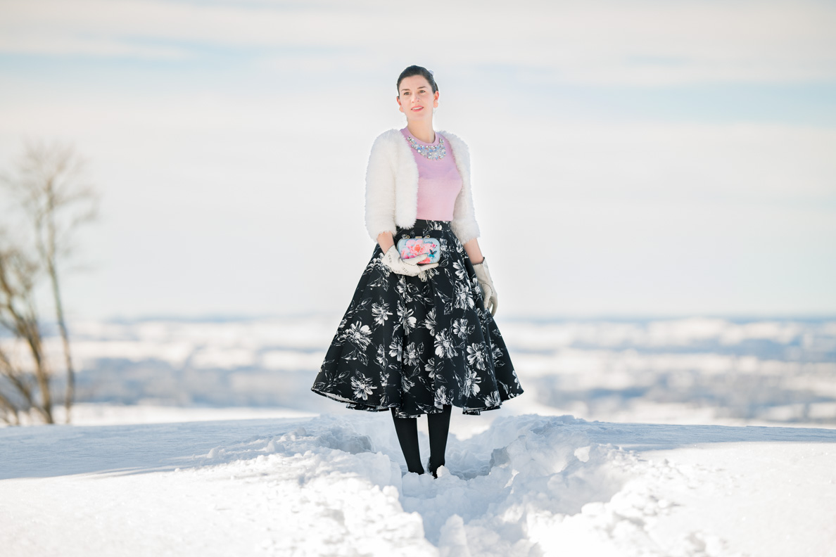 RetroCat wearing a feminine winter outfit in the snow