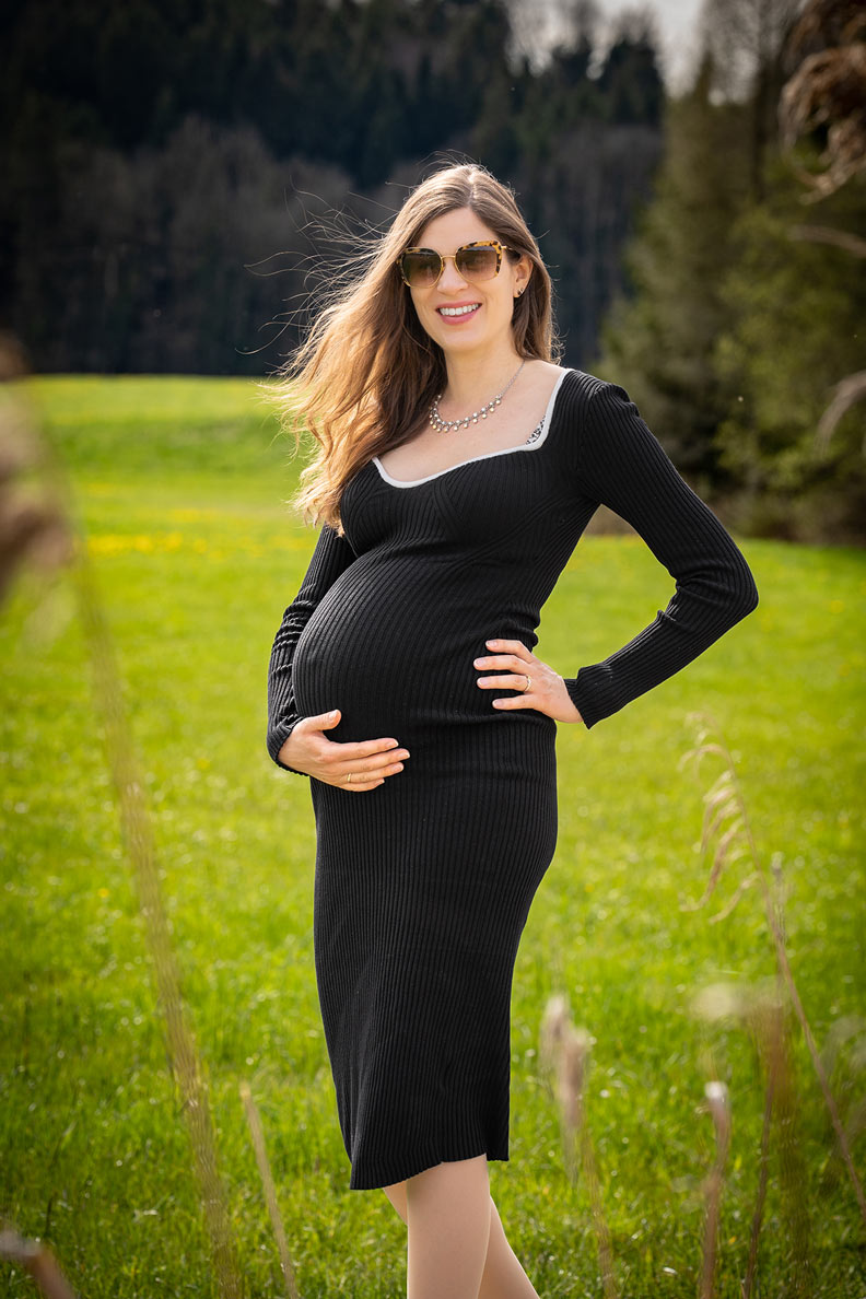 Pregnant RetroCat wearing a black dress