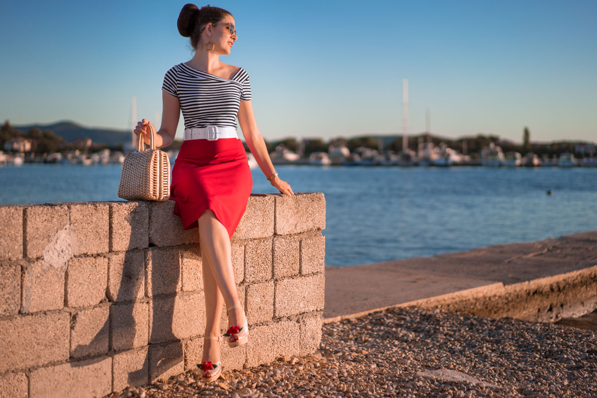 RetroCat wearing a striped shirt with a red skirt