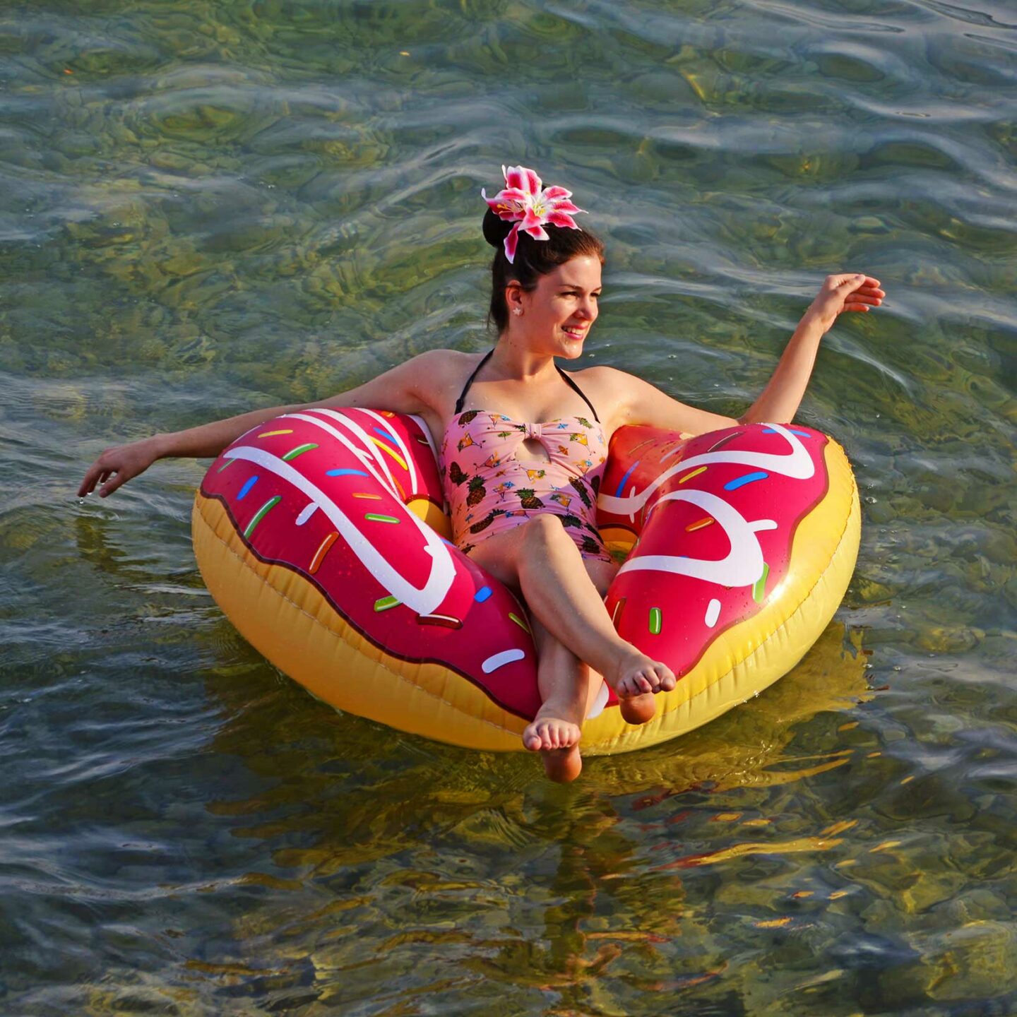 RetroCat wearing a pink swimsuit at the sea