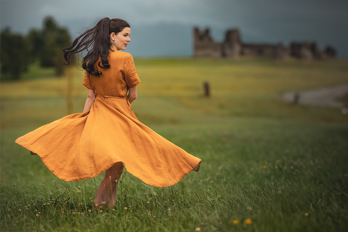 RetroCat wearing a yellow linen dress by Son de Flor in nature