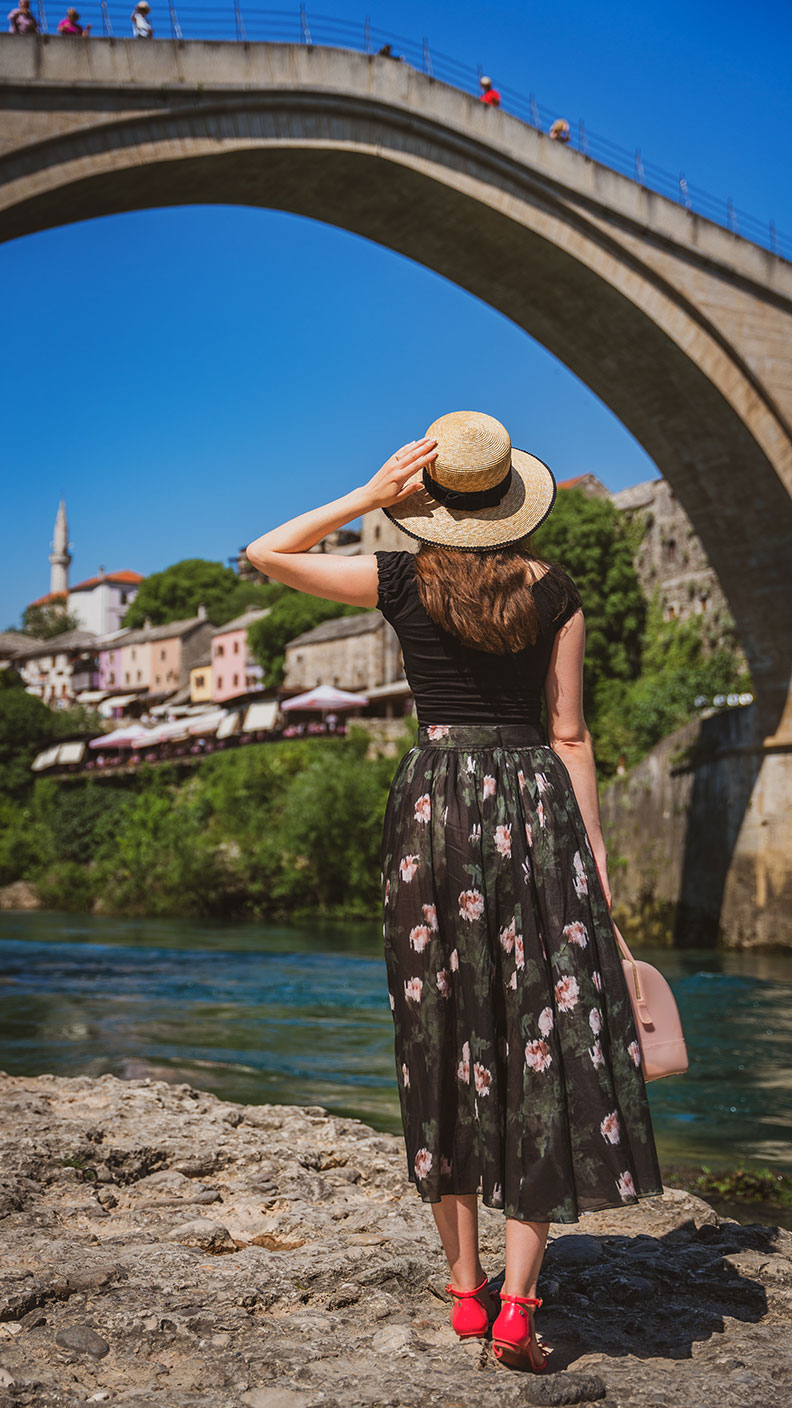 RetroCat with a floral skirt by Ginger Jackie in front of Stari Most in Mostar
