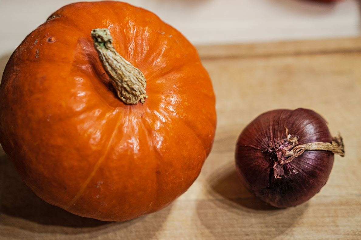 Ein Hokkaido-Kürbis und eine rote Zwiebel für einen warmen Orzo-Salat