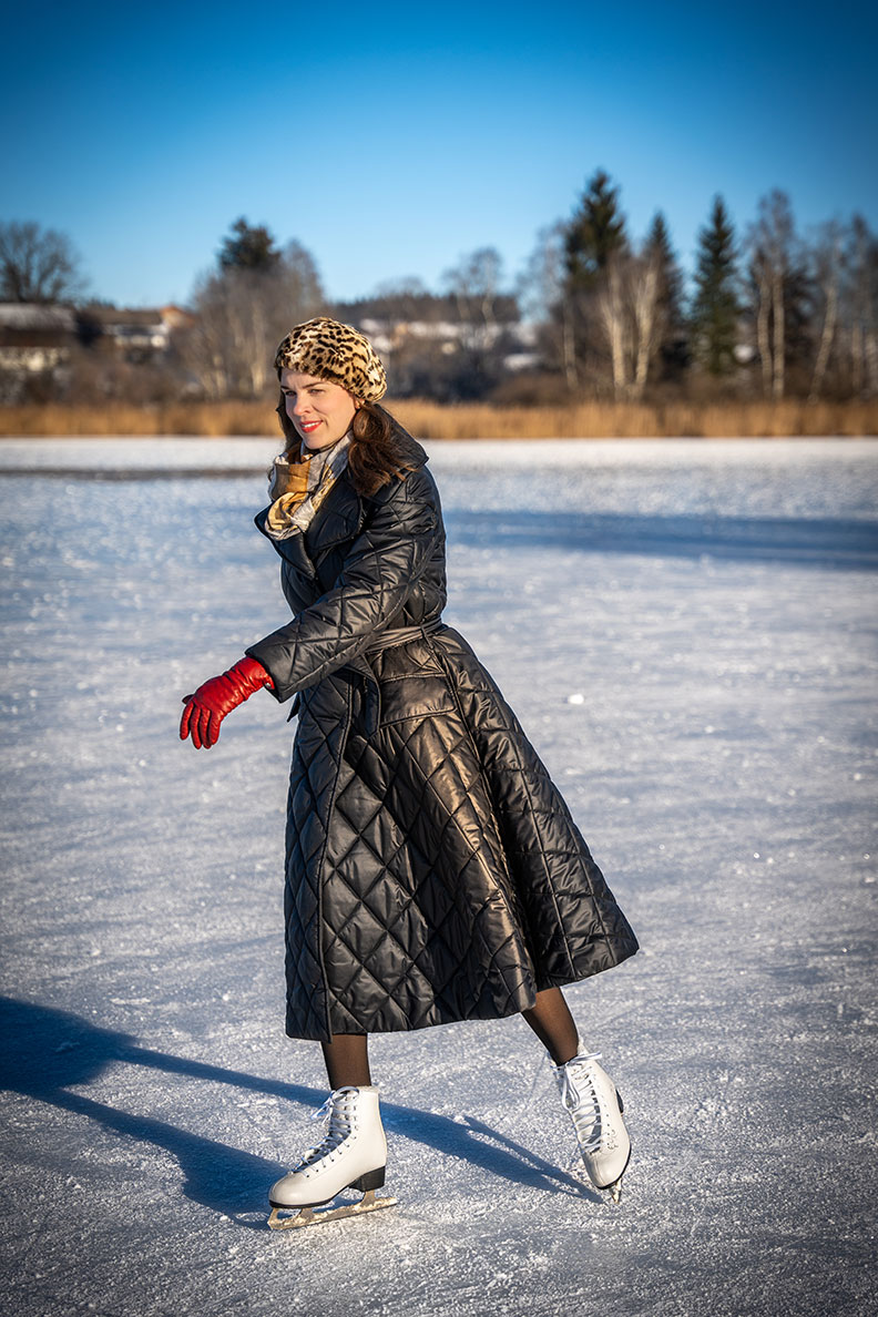 RetroCat with a warm retro coat and skates on the ice