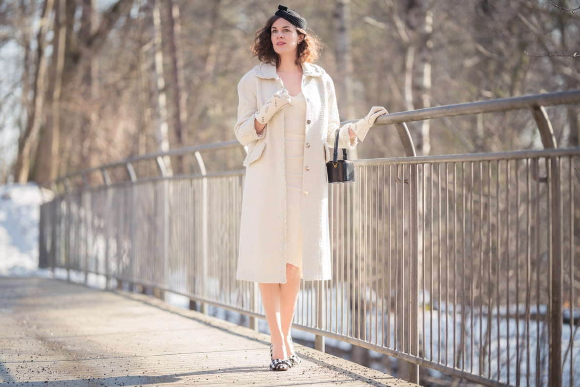 RetroCat wears a white coat and black vintage accessories