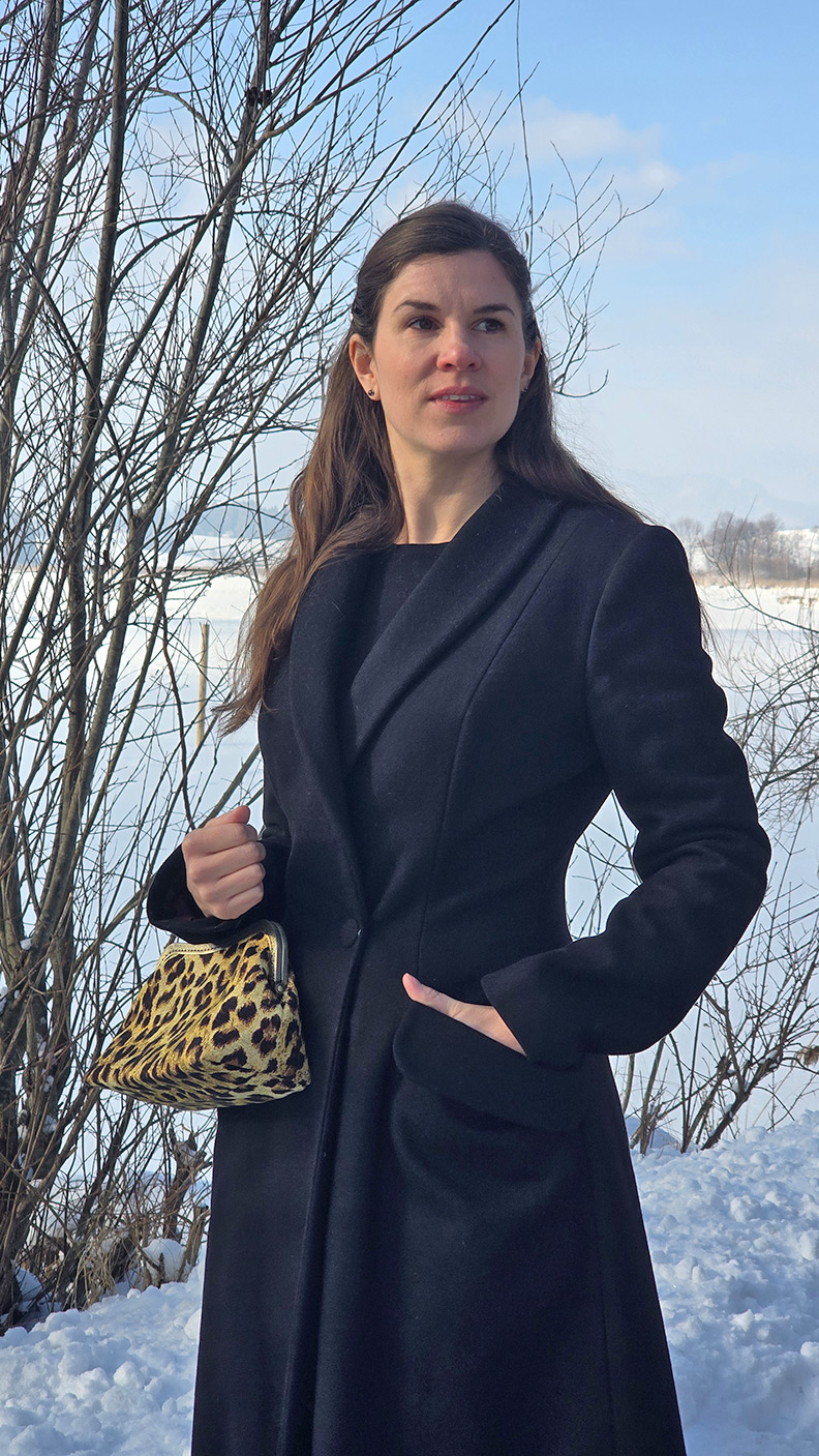 RetroCat wearing an elegant black winter coat