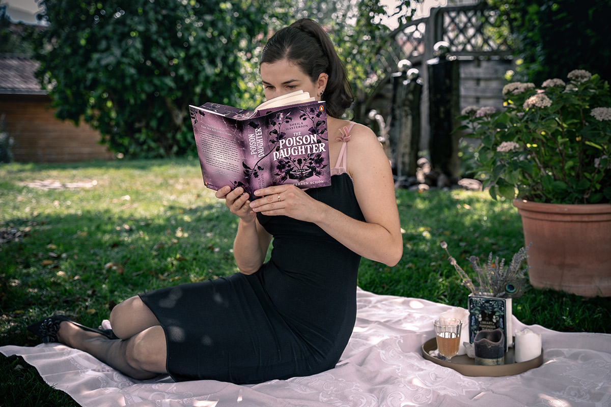 RetroCat reading the Romantasy The Poison Daughter by Sheila Masterson