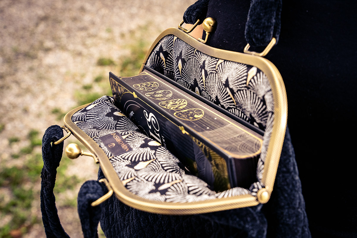 "The Ordeals" with stunning sprayed edges and black and gold accents.