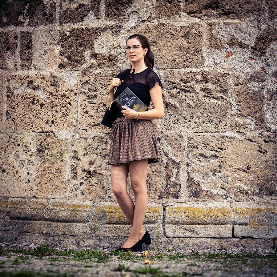RetroCat with a Dark Academia outfit and The Ordeals fantasy book.