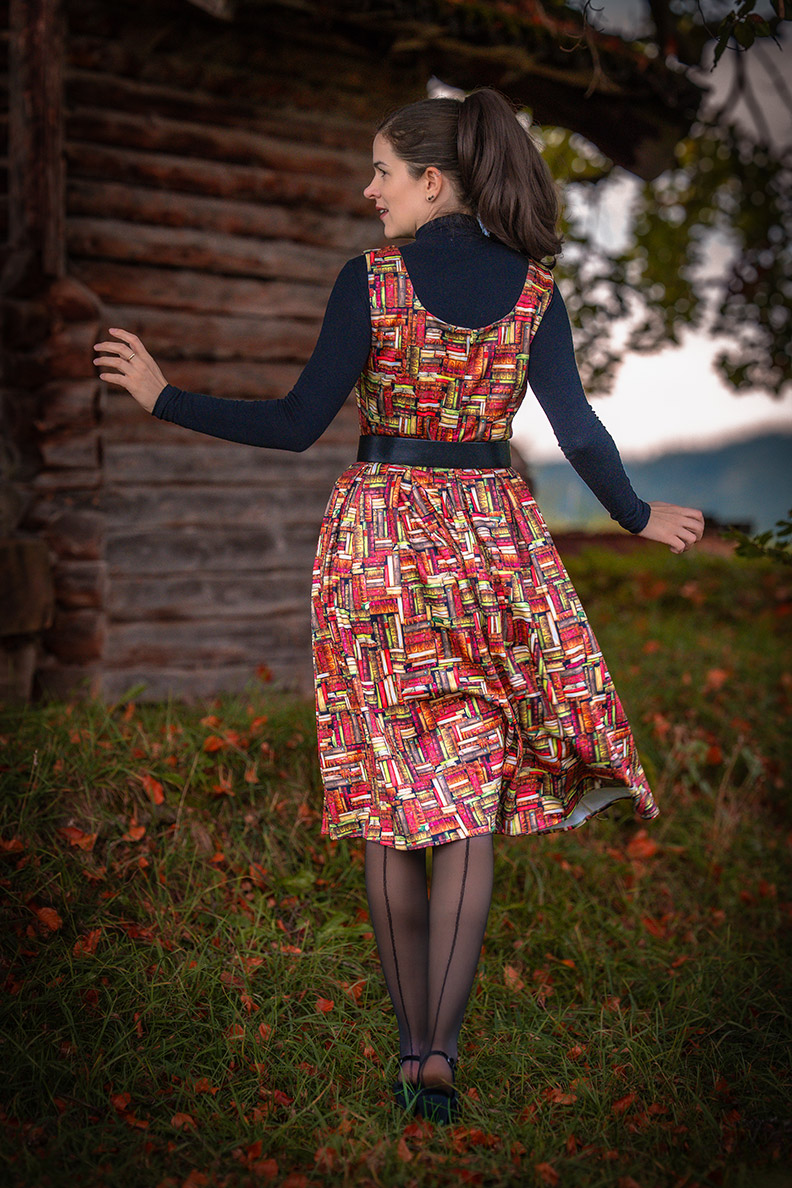 RetroCat in a retro dress with a book print and seamed tights